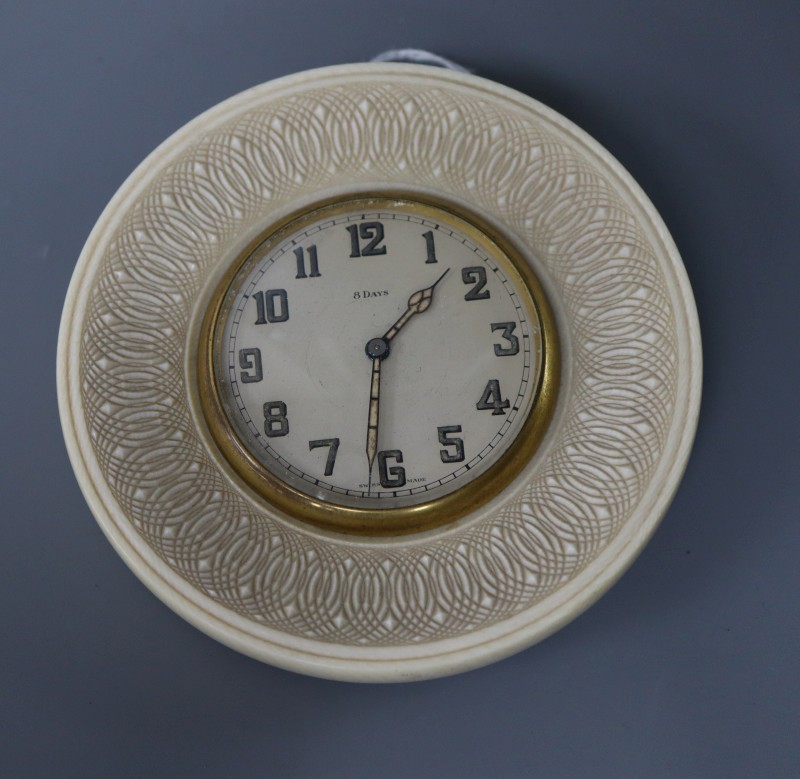 An eight day ivory travelling clock, diameter 11cm